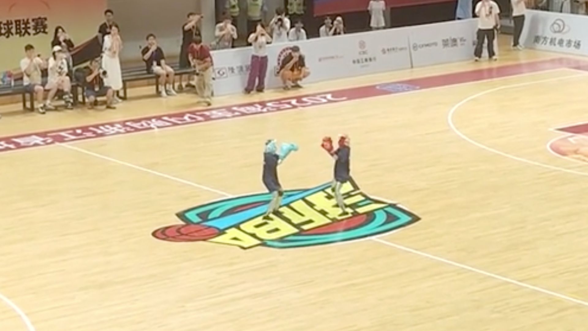 Chinese humanoid robot faceplants during a boxing match, crowd left in splits