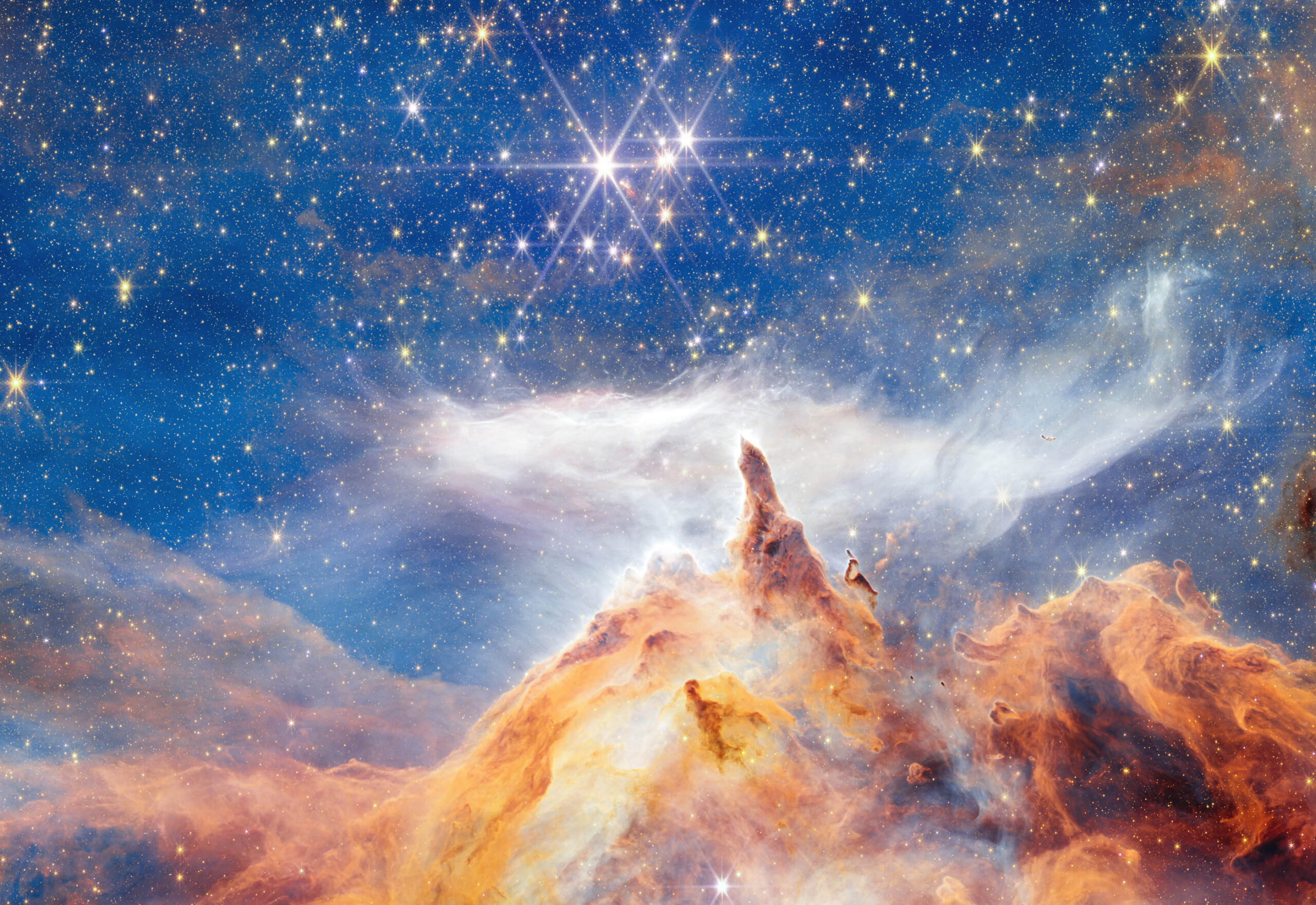 New Webb image shows star formation as glittering, craggy peaks
