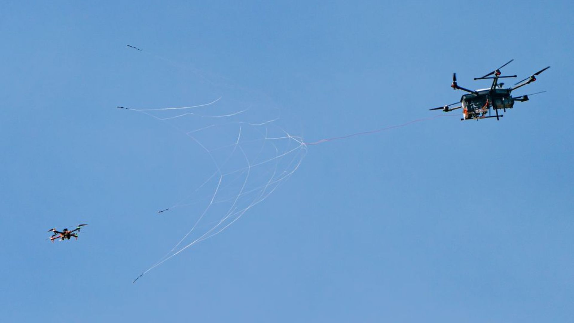 US interceptor drone with net-gun can defend infrastructure from UAV swarm attack